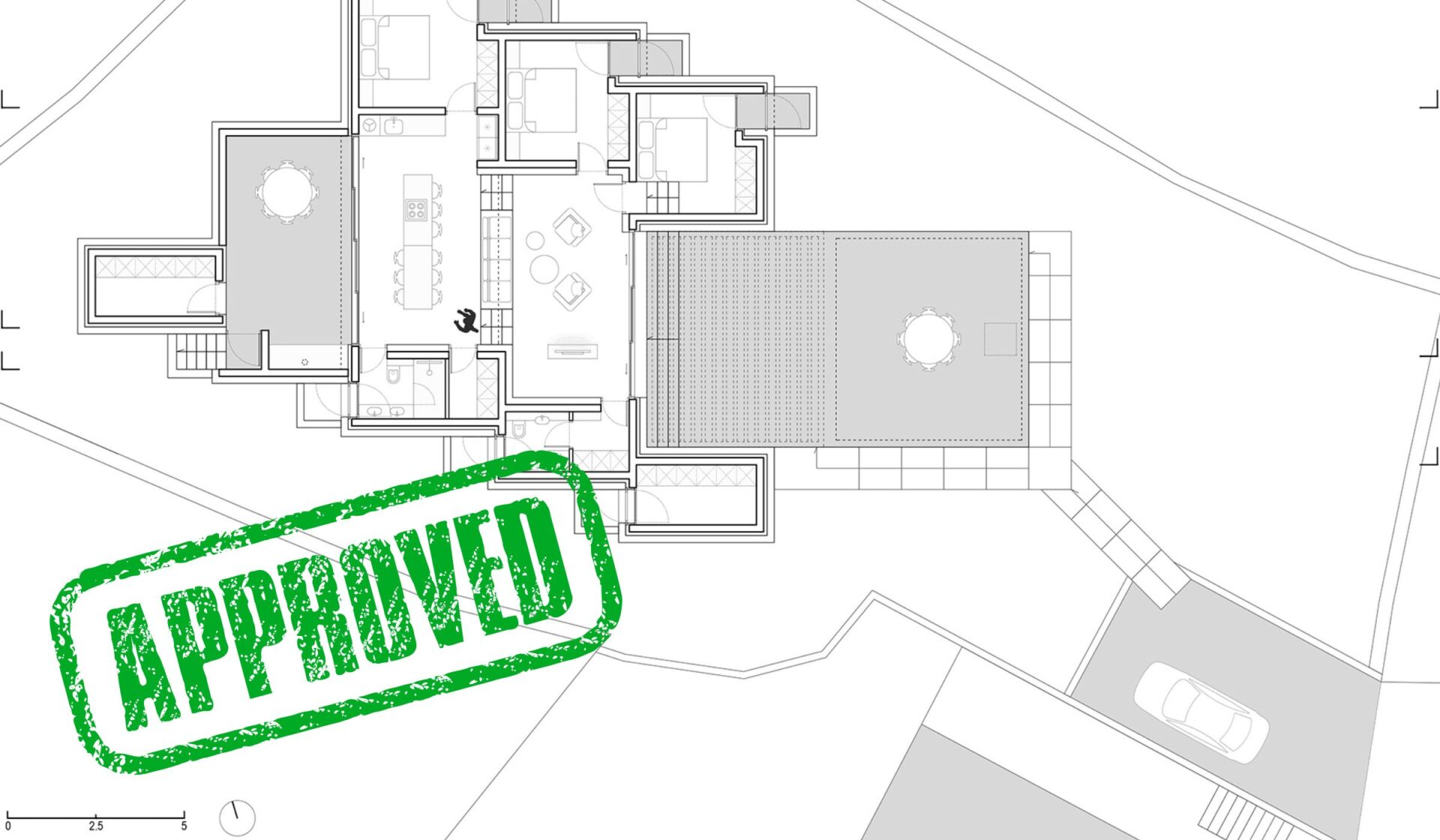 Building permits, documentation and an approved permit on a desk